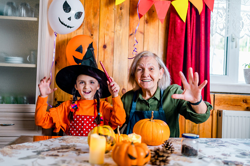 Grandmother and child celebrating Halloween at home.
