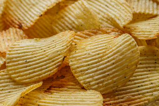Potato chips or crisps .Potato chips texture background flat overhead view.concept of fast food and snacks. Food background.
