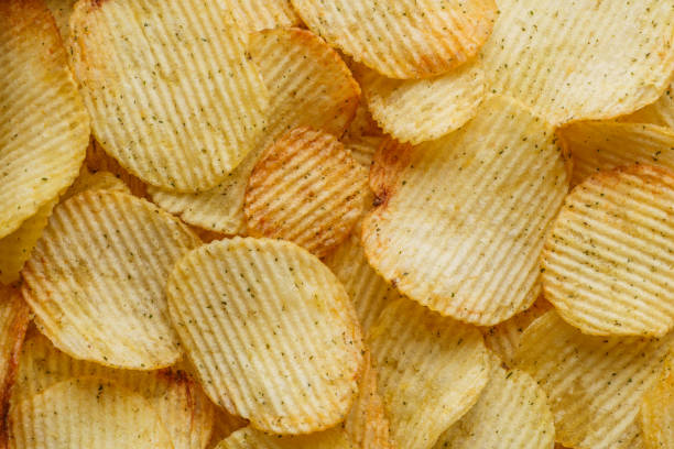 Potato chips or crisps .Potato chips texture background flat overhead view.concept of fast food and snacks. Food background. stock photo