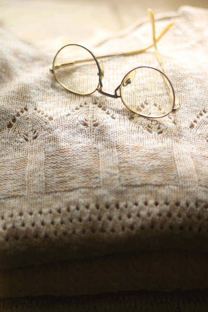 istock Pile of Sweaters and Glasses 1344933737