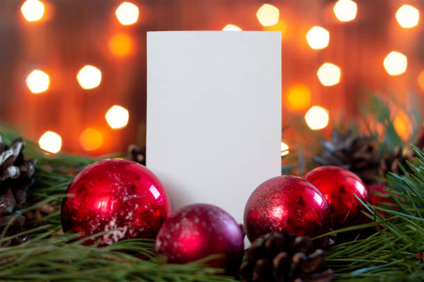 istock A white blank form for greeting text on a branch of a Christmas tree 1344935764