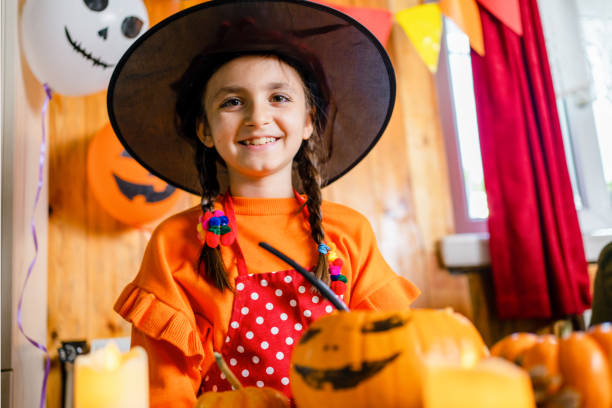 istock girl with pumpkin  in halloween 1344935850