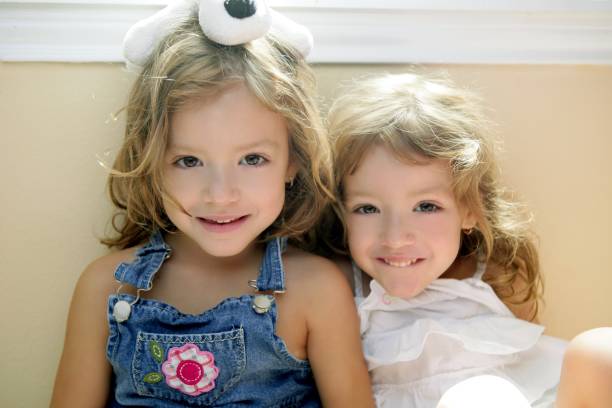 istock Two little beautiful toddler twin sisters 1344936038