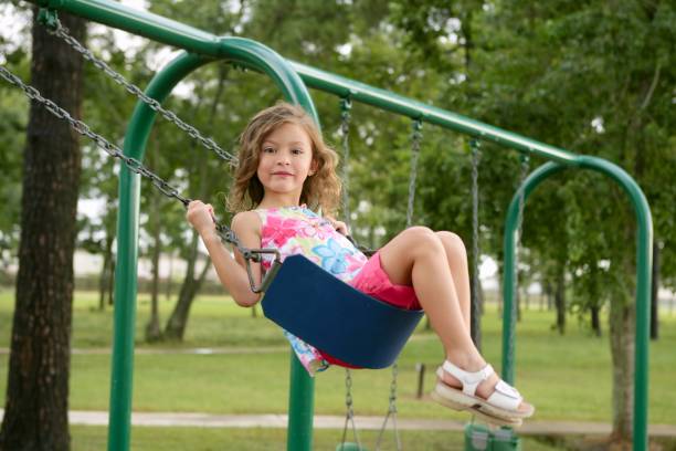 istock Beautiful little girl playing with swing 1344936099