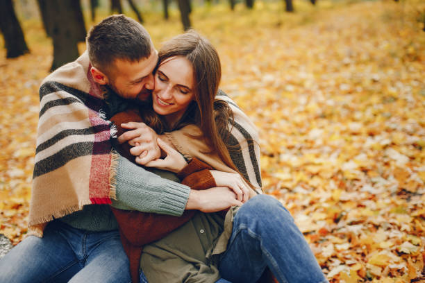 istock Beautiful couple spend time in a autumn park 1344936868