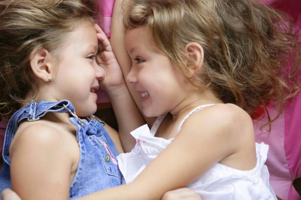 istock Two twin sisters in a hug, close up 1344936870