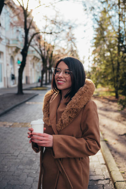 istock Young hispanic woman drinking coffee takeaway 1344937087