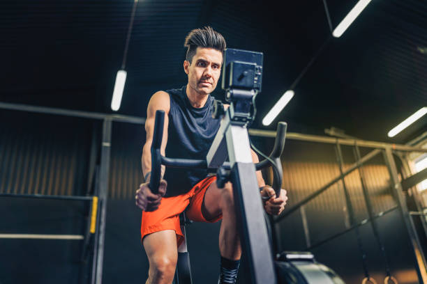 istock Determined athlete exercising on bike in gym 1344937532