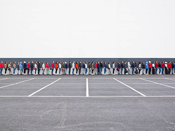 Waiting in Line Large group of people waiting in line people in a row photos stock pictures, royalty-free photos & images