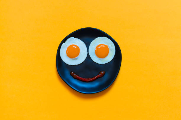 istock Two eggs in the black plate on the orange background 1344939712