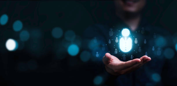 Businessman holding virtual human icon for focus customer group or human recruitment and development concept.