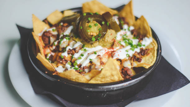 istock Nachos with cheese, meat, guacamole and tomato 1344943551