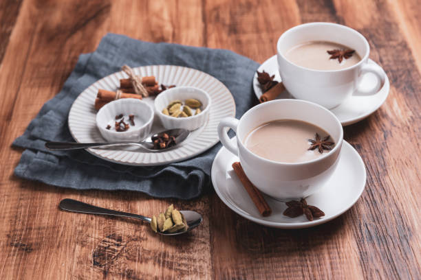 Indian masala chai tea. Spiced tea with milk on the rustic wooden table. stock photo