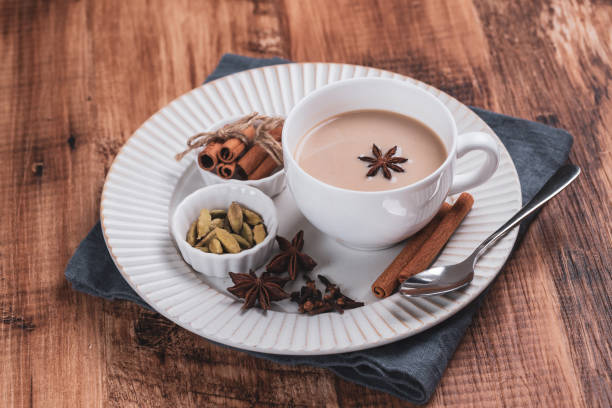 istock Indian masala chai tea. Spiced tea with milk on the rustic wooden table. 1344943636