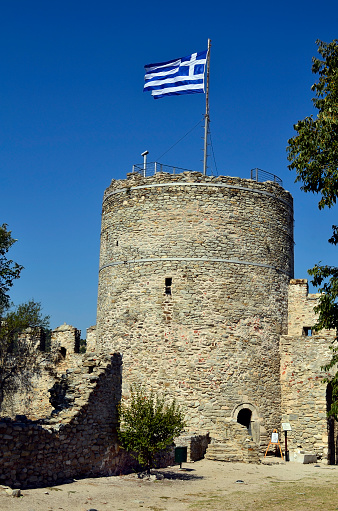 Kavala, Greece - September 27, 2011: Accessible tower in the medieval fortress of Kavala with Greek flag
