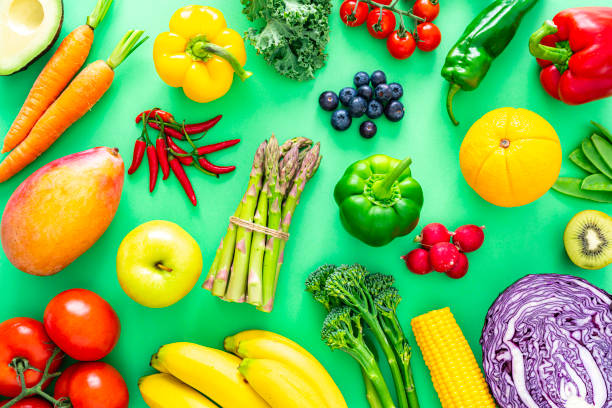 istock Fruits and vegetables on green background 1344947178