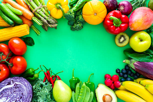 istock Fruits and vegetables border on green background 1344947203