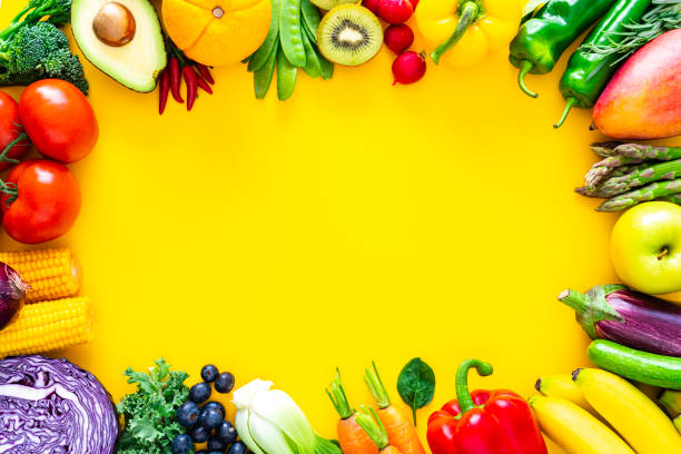 istock Fruits and vegetables border on yellow background 1344947204