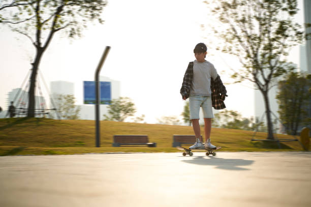 istock asian boy skateboarding outdoors 1344947270