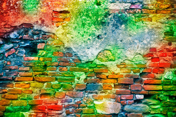istock Old colorful stone and brick wall background with multi colored rainbow effect 1344947318