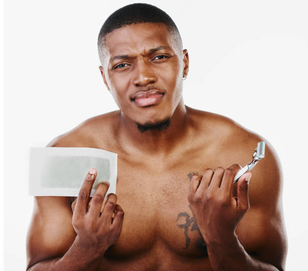 istock Studio portrait of a handsome young man deciding between waxing or using a razor against a white background 1344948085
