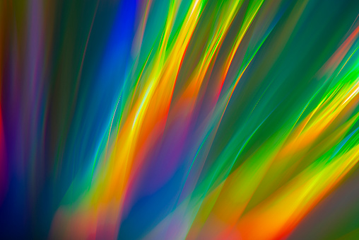 Image of the reflecting surface of shiny object illuminated with sun light. Abstract spectrum background