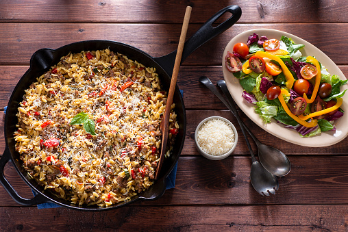 One-skillet Meal with Orzo, Italian Sausage, Roasted Red Pepper, Cherry Tomatoes, Parmesan Cheese and Basil.