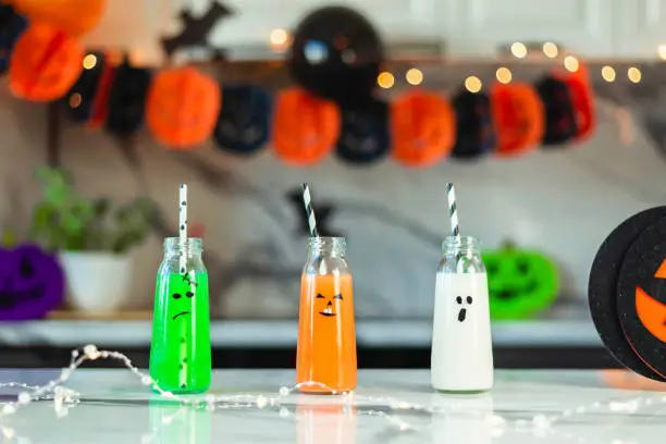Scary drinks in funny bottles for a Halloween party. Traditions, holidays, treats concept