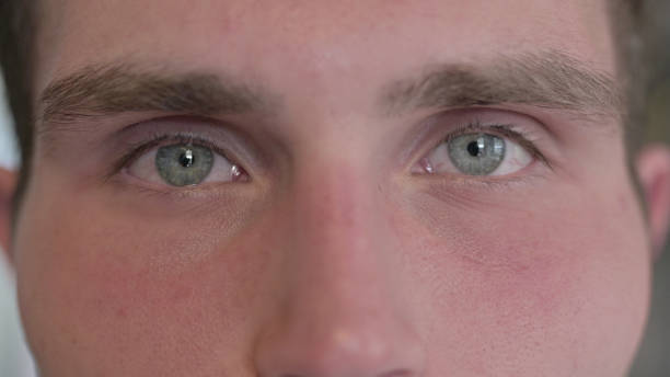istock Close Up of Young Man Blinking Eyes in Camera 1344950560