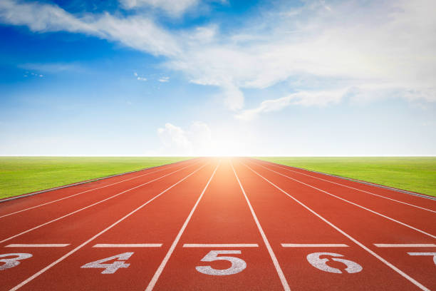 istock Athlete running track with number on the start. Day scene 1344950933