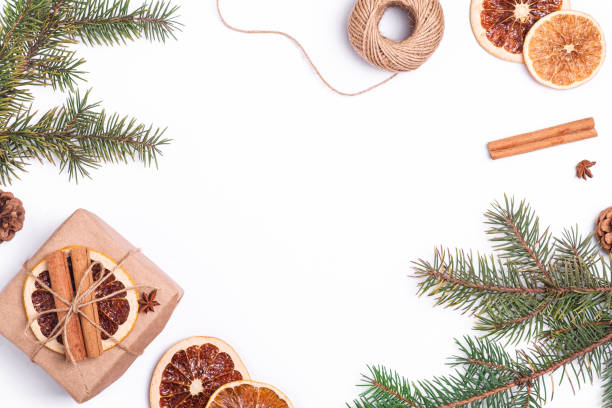 istock Christmas composition with handmade kraft paper gift box, dried citrus slices, cinnamon, anise, pine cones and fir tree branches, top view copy space 1344951036