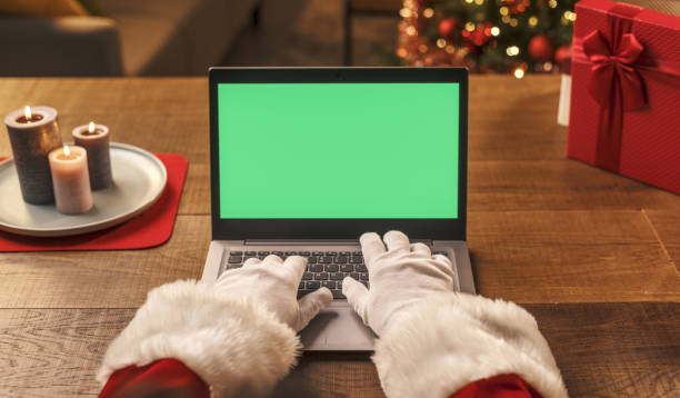 istock Santa Claus connecting with his laptop 1344951928