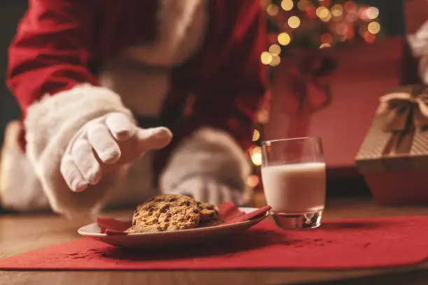Photo of Santa Claus having a delicious snack