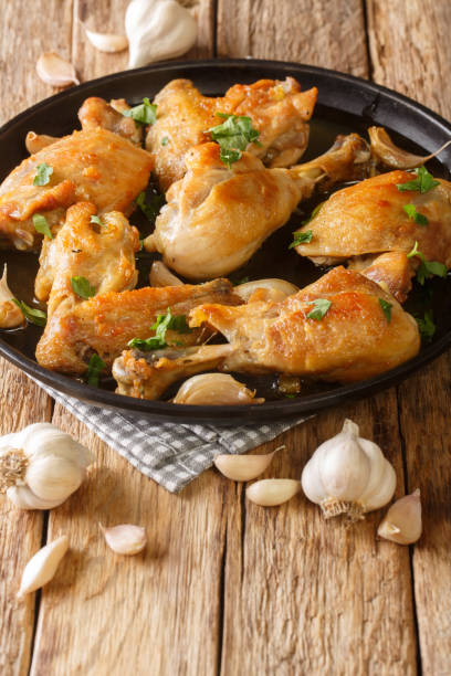istock Pollo Al Ajillo Classic Spanish Fried Garlic Chicken close-up on a plate. Vertical 1344955151