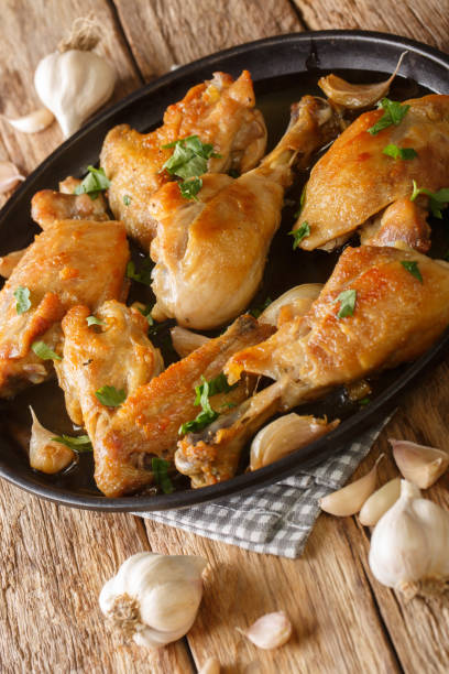 istock Spanish Garlic Chicken Pollo Al Ajillo close-up on a plate. Vertical 1344955668