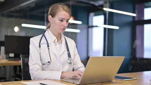istock Young Female Doctor Working on Laptop in Office 1344957765