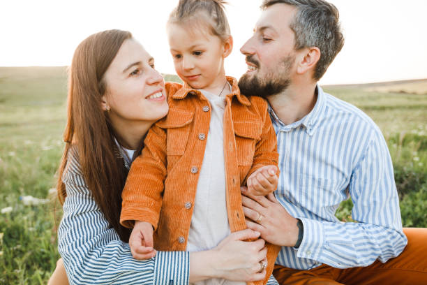 istock A hipster family walks in a summer field. 1344958637