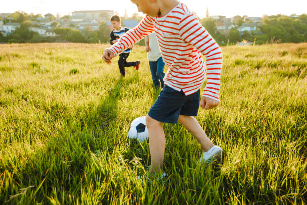 istock School-age boys play soccer during the summer holidays. 1344958700