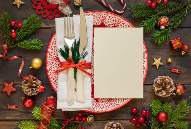 istock Festive table setting of with fir tree branches and Christmas decorations. Greeting card mockup 1344961836