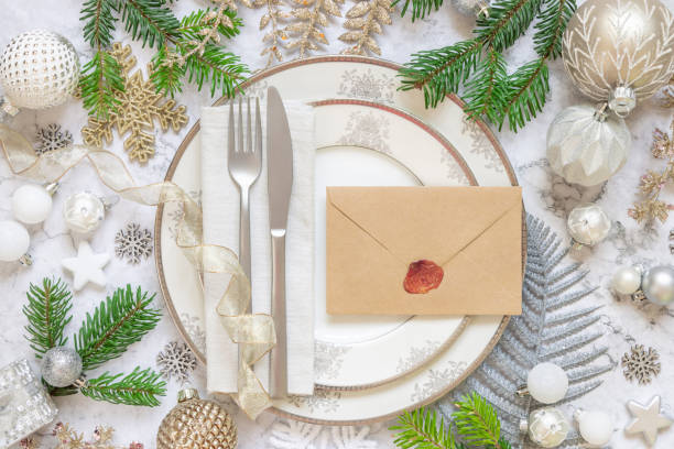 istock Festive table setting of with fir tree branches and Christmas decorations. Envelope mockup 1344961853