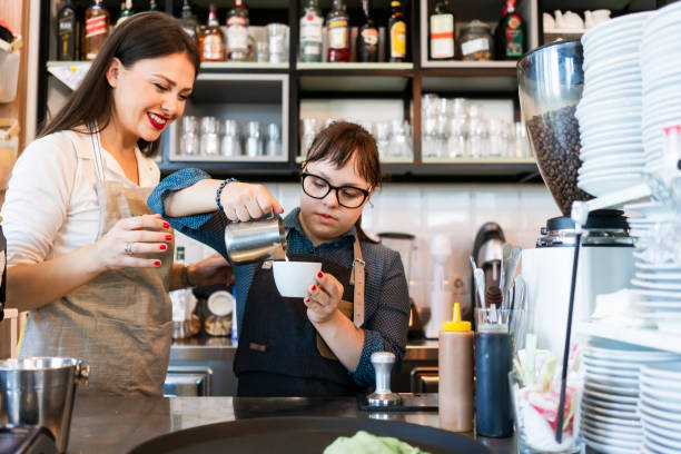istock Young woman with Down Syndrome working at cafe 1344963367