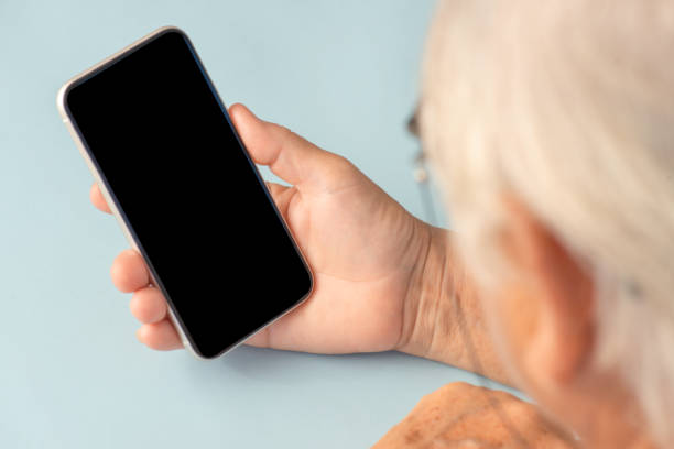 istock Old Woman Looking Smart Phone 1344963497