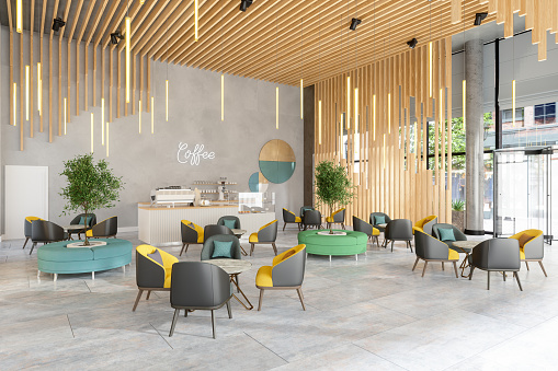 Cafe Interior With Leather Armchairs, Round Tables And Pendant Lights