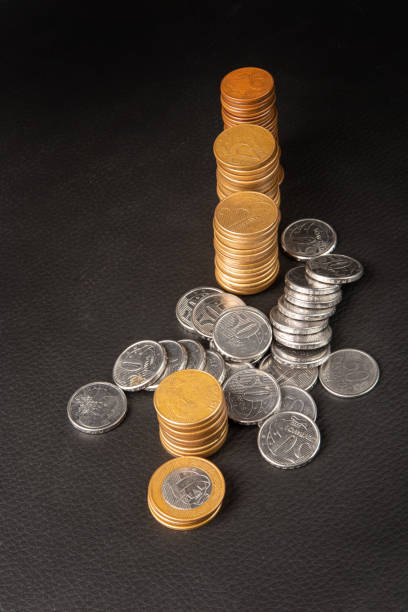 istock Coins, Brazilian coins of various values on black leather, selective focus. 1344966027