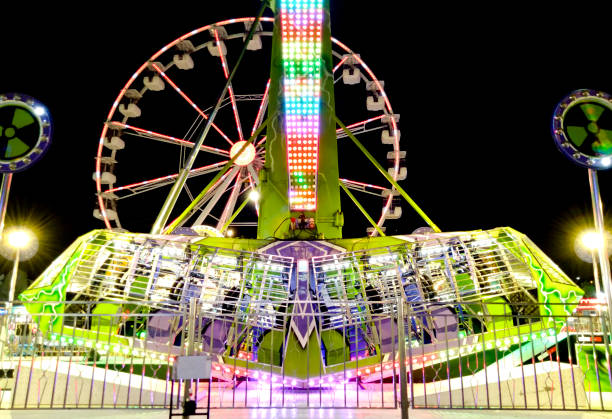 istock pendulum amusement ride and Giant Wheel 1344967358