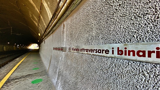 do not cross the railway lines - posted warning sign at trenitalia platform # 3 - monterosso al mare train station, la spezia, italy.