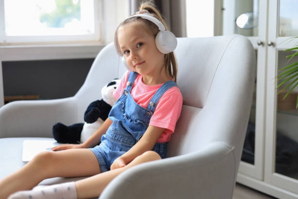 istock Cheerful girl girl in headphones studying through online e-learning system. 1344969420