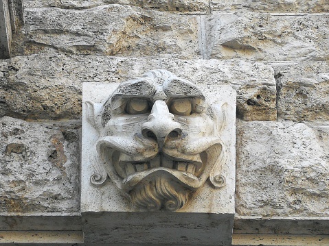 Close up of an animal masc on the building facade