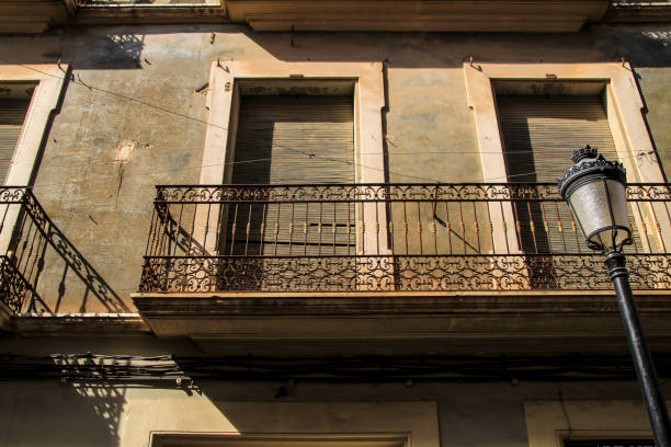 istock Old house facade with rusty balcony and blind 1344971859