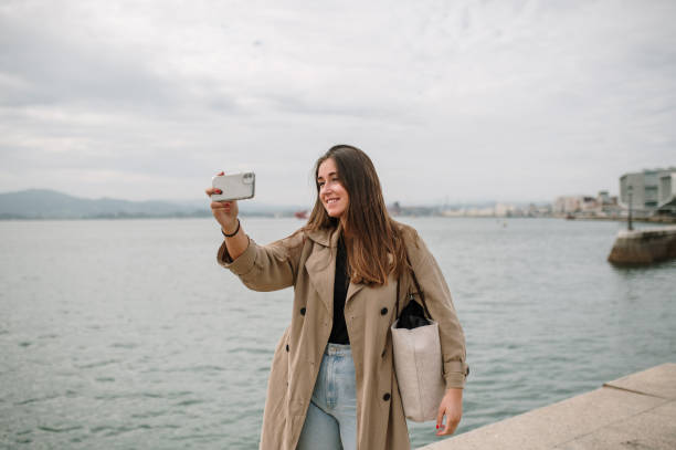 istock Young woman taking a selfie with a smart phone 1344972039